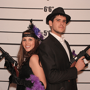 Kansas City Murder Mystery party guests pose for mugshots