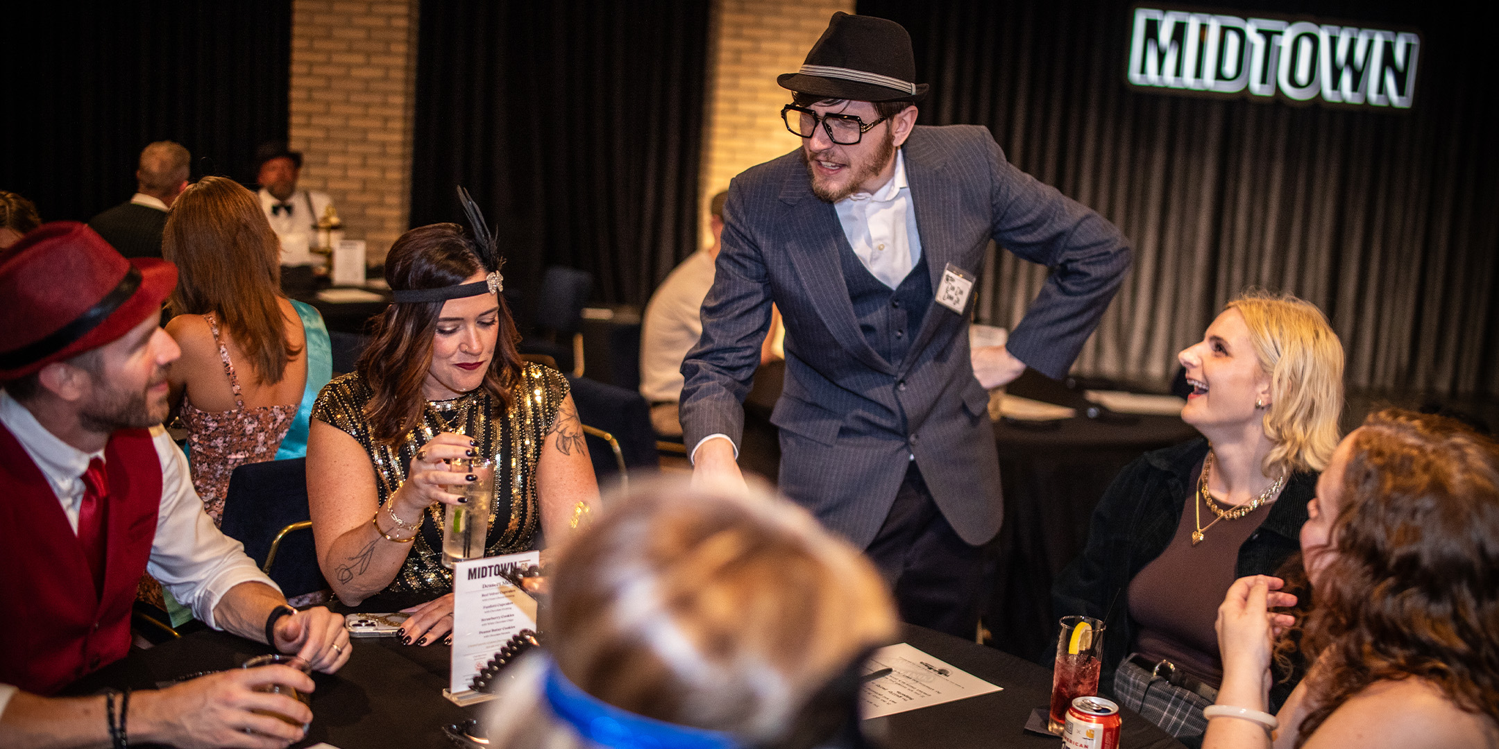 Guests at a Murder Mystery Company public dinner show in Kansas City