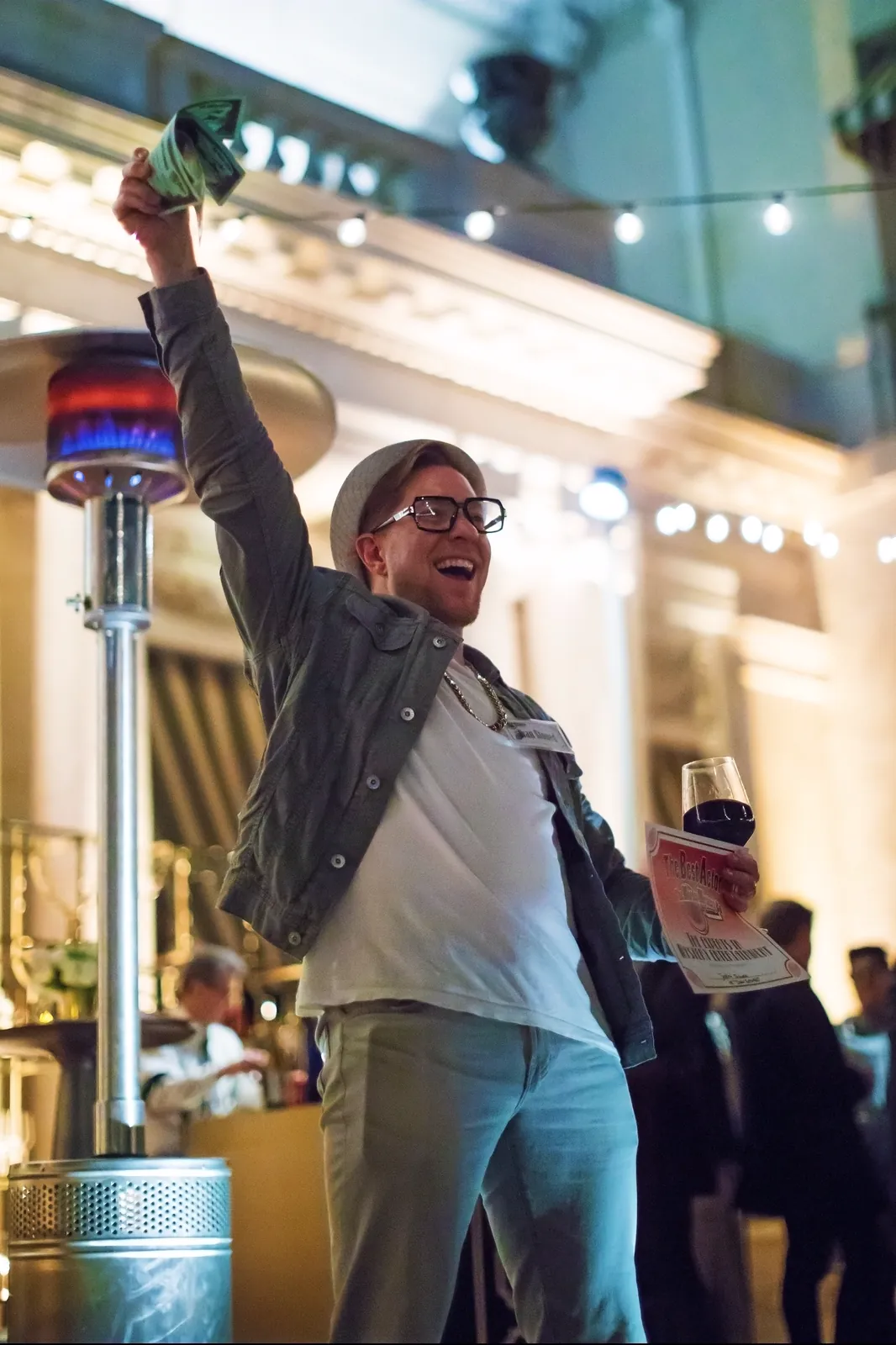 A guest celebrating at a Murder Mystery Company dinner show